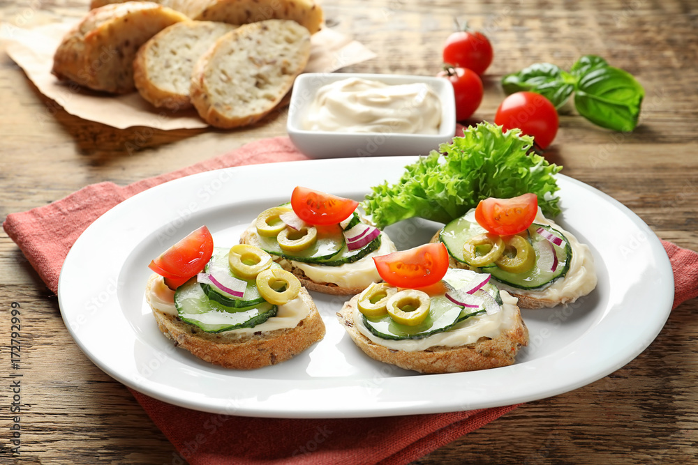 Plate of tasty sandwiches with fresh cucumber on table Plate of tasty sandwiches with fresh cucumber on table
