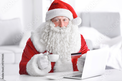 Santa Claus with laptop and...