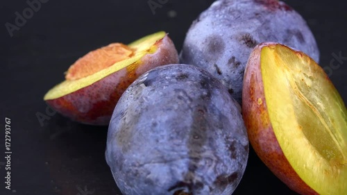 Some Plums rotating on a slate slab (4k; not loopable)