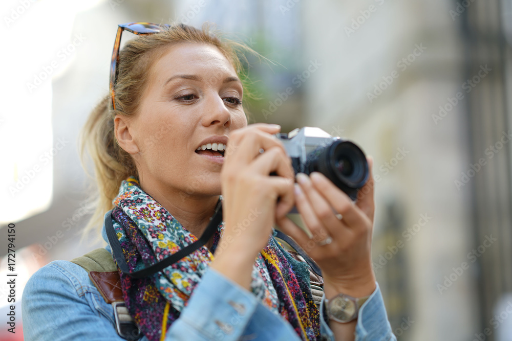 Cheerful woman taking picture on vacation day