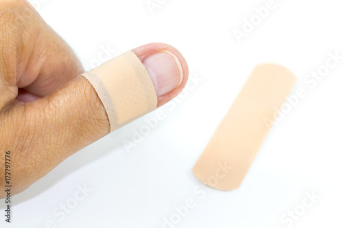thumb with bandage on white background.