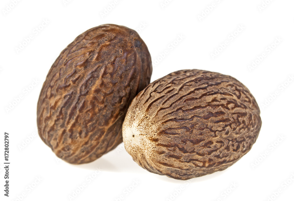 Two dry whole nutmeg isolated on a white background Two dry whole nutmeg isolated on a white background