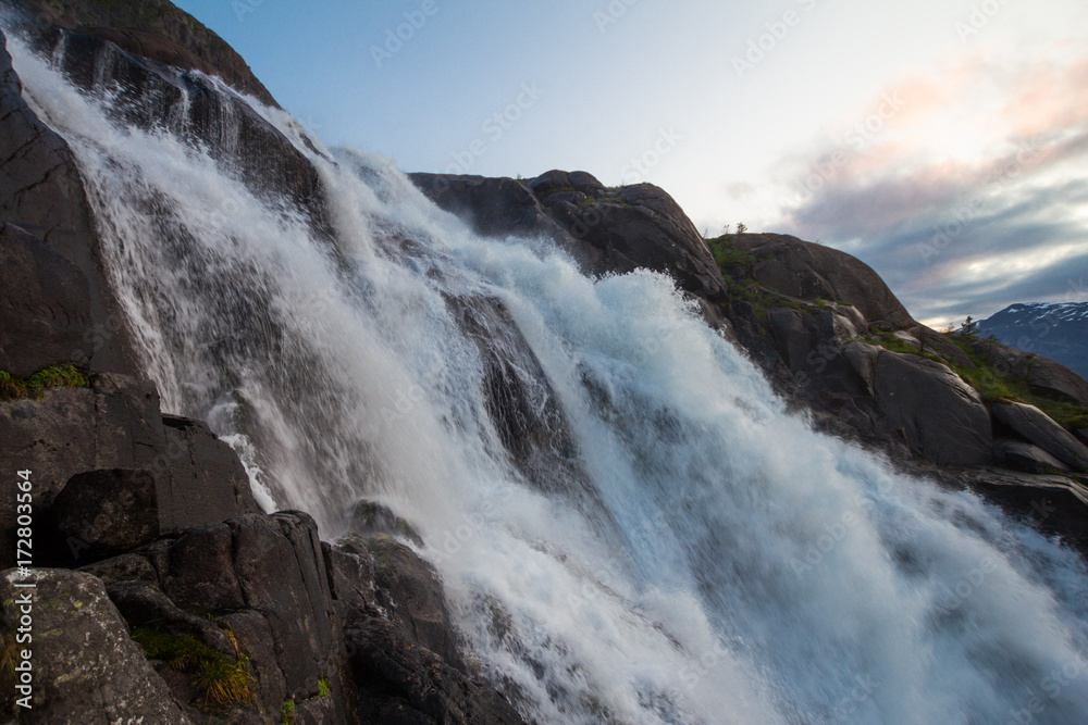 Summer mountain Langfossen waterfall on slope (Etne, Norway).