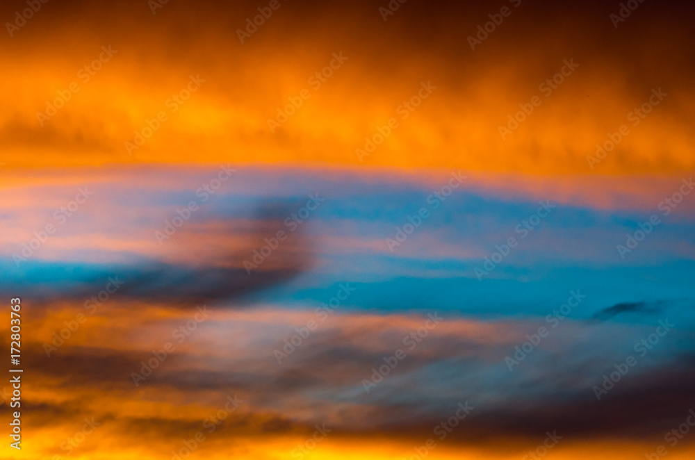 Background texture of dramatic sunset sky with orange clouds after thunderstorm