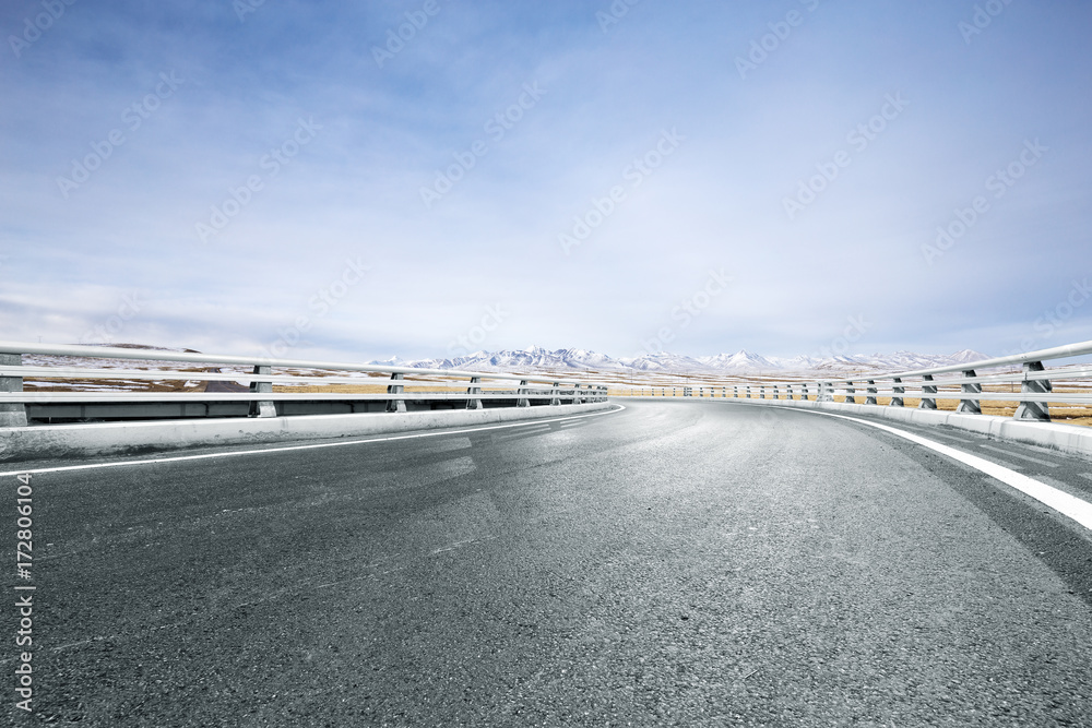 empty asphalt road with beautiful snow mountains empty asphalt road with beautiful snow mountains