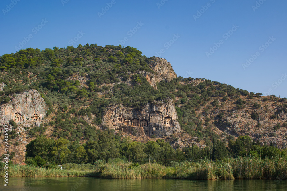 Rocky shores of the river Dalyan in Turkey with ancient Lycian tombs, selective focus