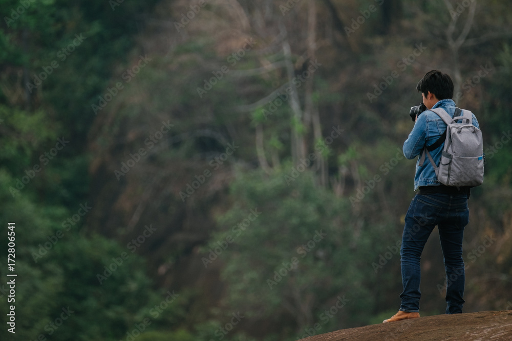Male Photographer on Three rock wale at Phu Sing, Bungkan, nature as a classroom. Under the supervision of the Department of Forestry Male Photographer on Three rock wale at Phu Sing, Bungkan, nature as a classroom. Under the supervision of the Department of Forestry