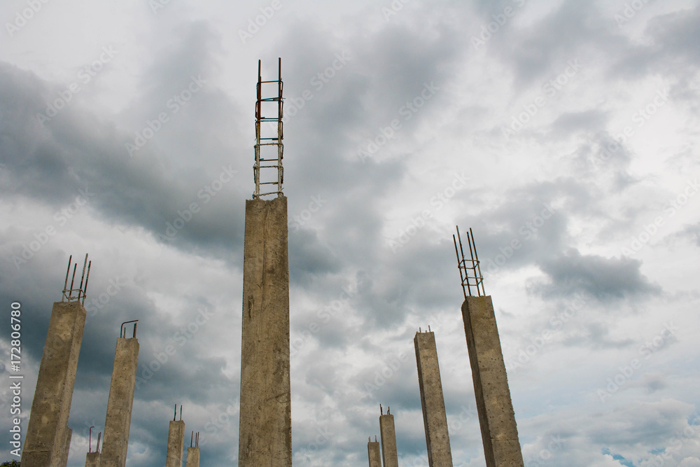 Concrete poles in construction site ,cement pillar with blue Cloud sky background
