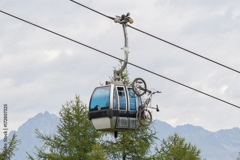 Ski lift cable booth or car with a mountainbike on the side (unmarked)