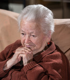 Portrait of old gray-haired sad woman