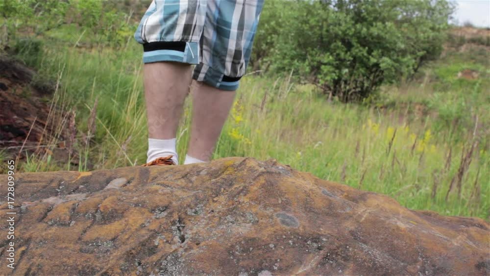 climbing on stone sneakers/becoming a sneaker in the mountains on a stones boy climbing on stone sneakers/becoming a sneaker in the mountains on a stones boy