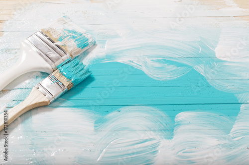 brush with paint on wooden background
