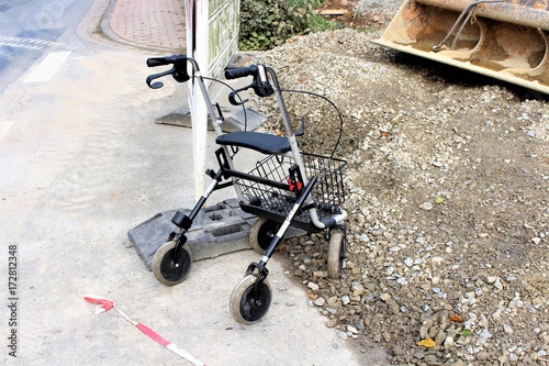 An image of a rollator in front of a construction site
