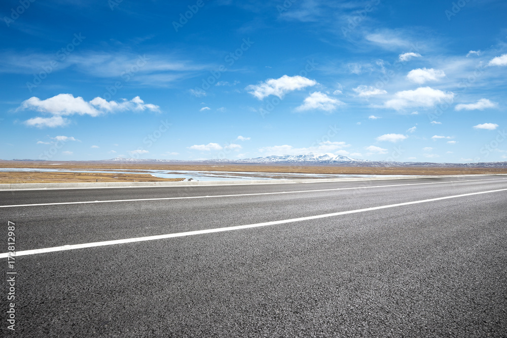 Fototapeta premium empty asphalt road with snow mountains