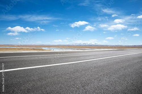 empty asphalt road with snow mountains © zhu difeng