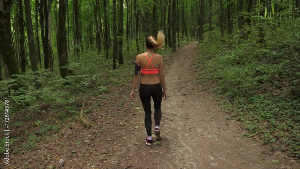 Slender Sports Woman Stretch And Stretch Muscles In The Park Before Running Slender Sports Woman Stretch And Stretch Muscles In The Park Before Running