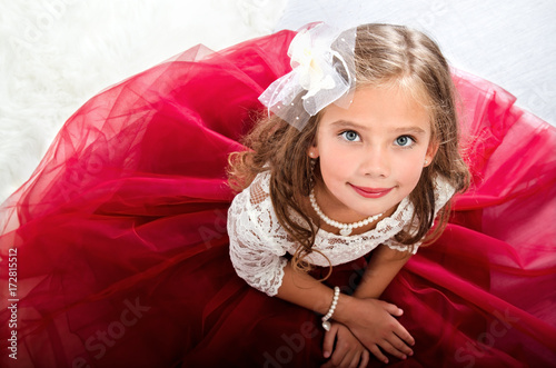 Adorable smiling little girl child in princess dress