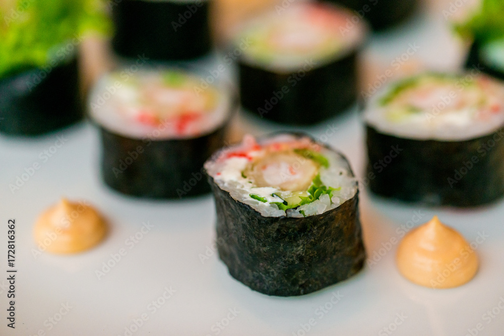 Fresh sushi rolls served on plate in restaurant Fresh sushi rolls served on plate in restaurant