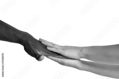 One caucasian and one african hand on white background