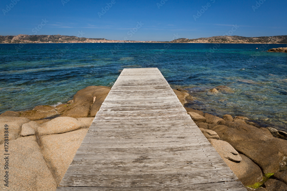 wooden pier on the beach directing to the sea,