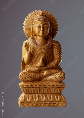 Statue of wooden Buddha. isolated gray background. © spf