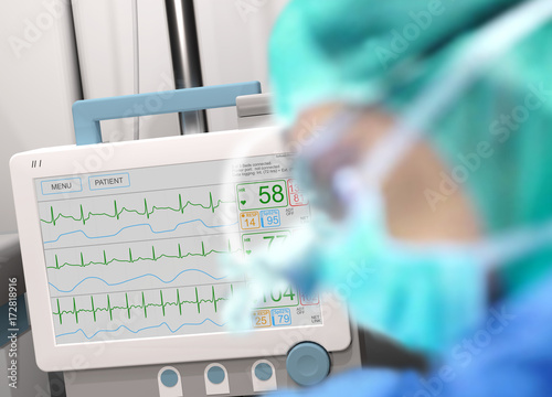Intensive care unit (ICU) LCD monitor, light screen, with an ongoing surgery in foreground