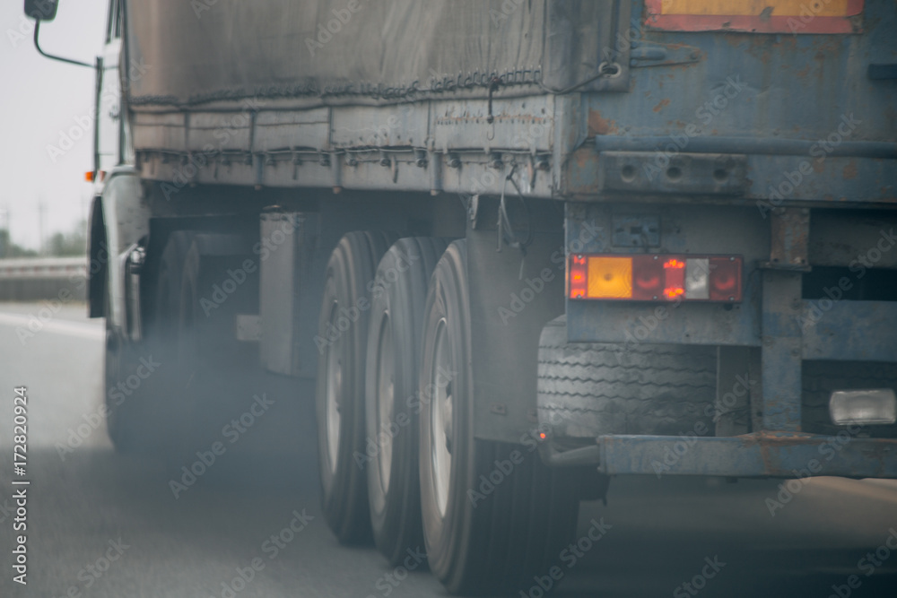 Obraz premium Air pollution from truck vehicle exhaust pipe on road