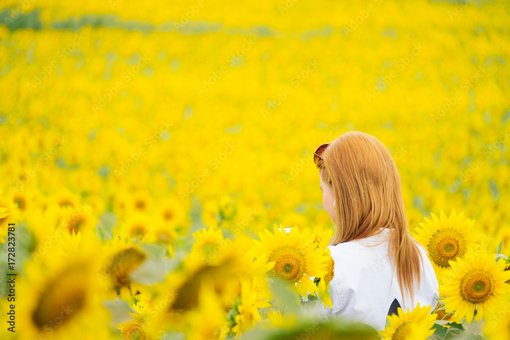 Asian woman in look at the sunflower in the garden Asian woman in look at the sunflower in the garden