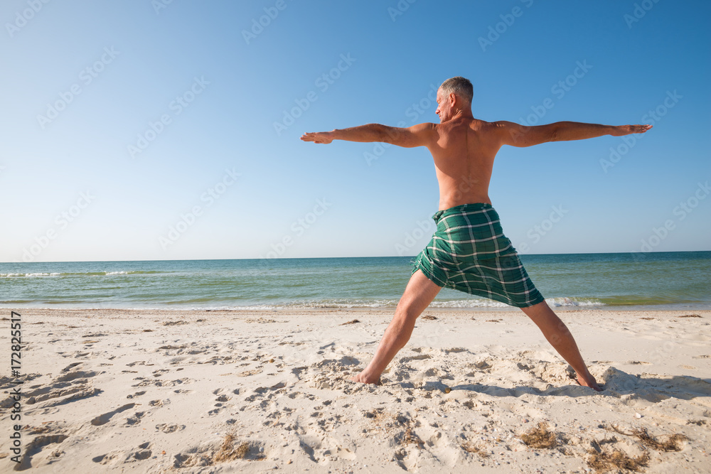 Concentrated caucasian man performs asana of yoga Concentrated caucasian man performs asana of yoga