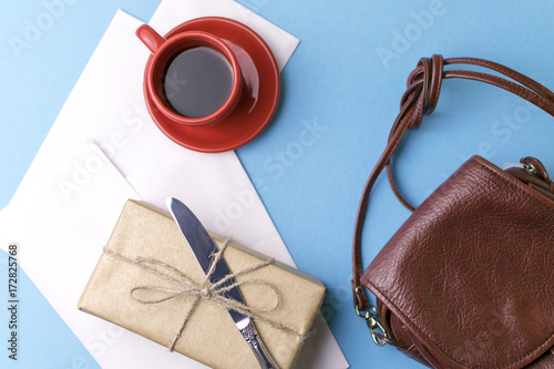 Bag, gift, letter, Cup of coffee, a knife on a blue background.