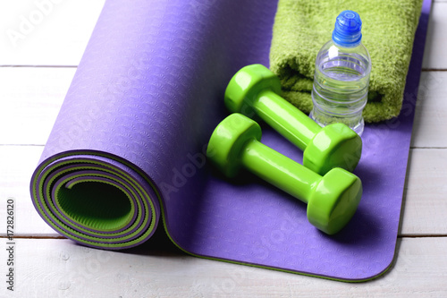 Dumbbells made of green plastic  towel and water bottle