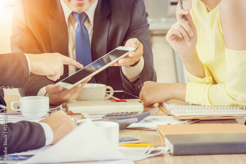 Obraz premium Group of Business Team Meeting Strategy Marketing in a coffee shop chatting to each other while using smartphone tablet and laptop internet of things conceptual