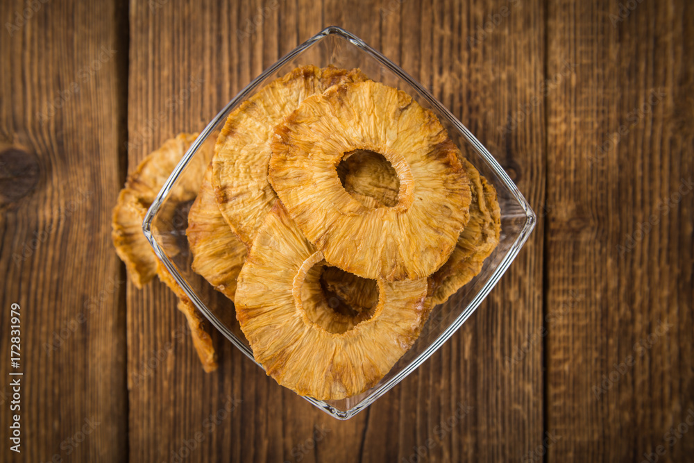 Fresh made Pineapple rings (dried) on a rustic background Fresh made Pineapple rings (dried) on a rustic background