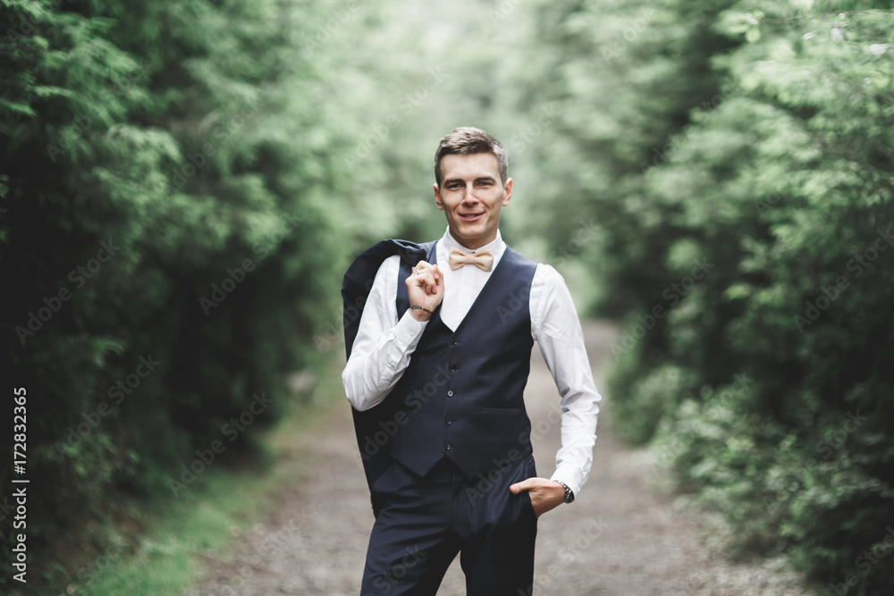Young handsome man posing on mountain forest Young handsome man posing on mountain forest