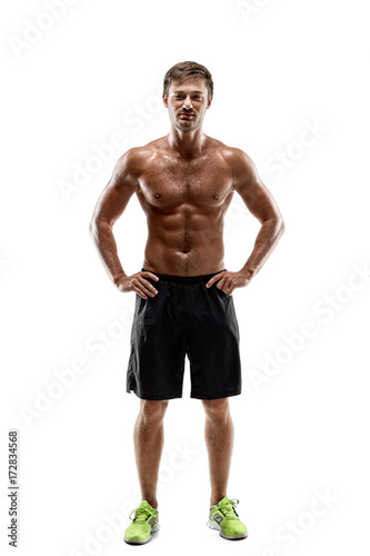 Portrait young sexy handsome man of strong athlete's body with bare torso. Posing on white studio background