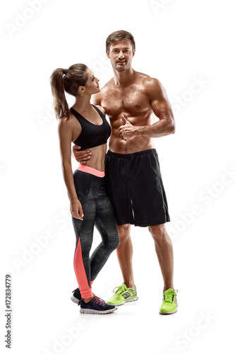 Young sportsmen couple woman and man in studio on white background