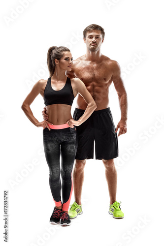 Young sportsmen couple woman and man in studio on white background