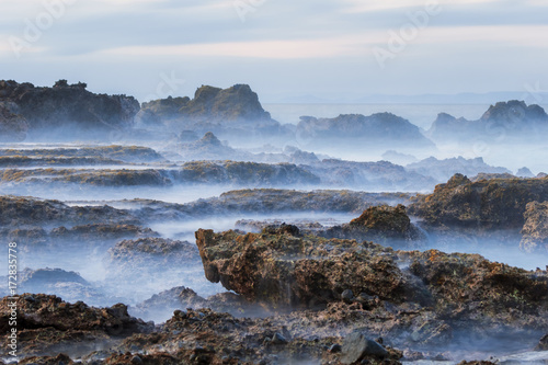 Beautiful Tanjung Layar Beach, Sawarna during sunset in Banten, West Java Indonesia photo