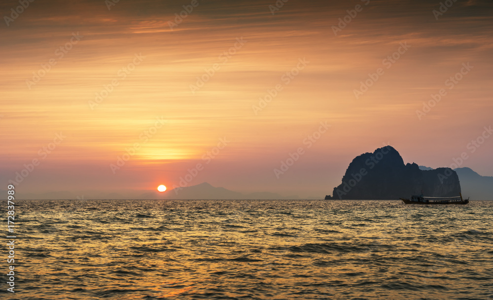 sunset seascape on golden time and boat silhouette