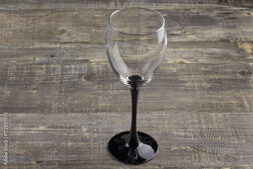 A wine glass on old wooden table. Background