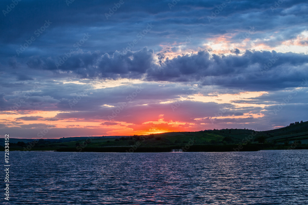 Summer landscape. Sunset over water.