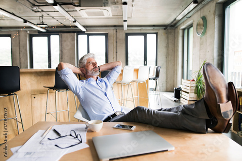 Thoughtful mature businessman in the office.