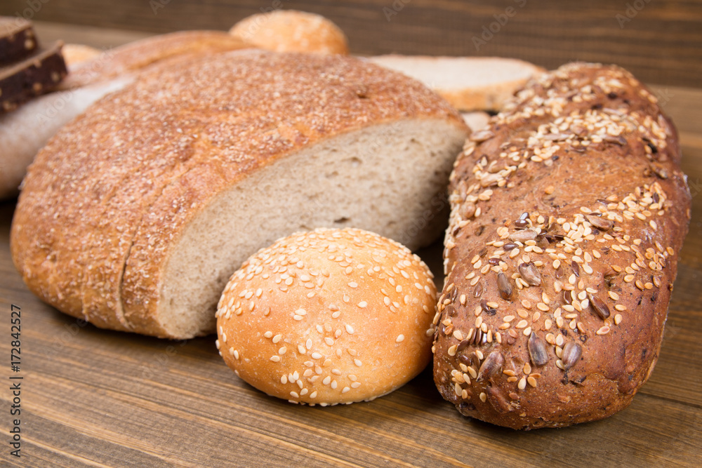 Mixed frash baked bread on wooden background