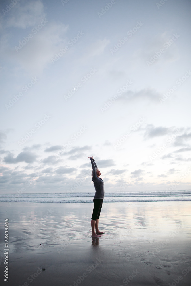Vibrant mature woman enjoying herself on the beach at sunset Vibrant mature woman enjoying herself on the beach at sunset