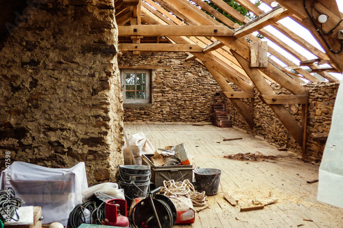 Old typical stone wall house undergoing a roof renovation - French countryside