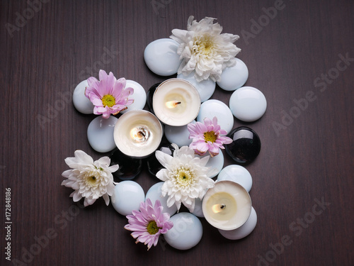 Spa still life concept Close up of spa theme on wood background with burning candle and bamboo leaf and flower