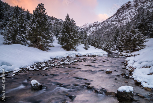 Sunrise on a snowy river of Ordino