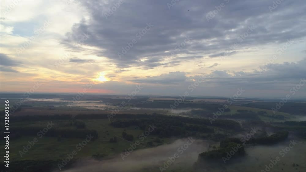 Aerial view ,high flying above fields, forest and lake at misty morning Aerial view ,high flying above fields, forest and lake at misty morning