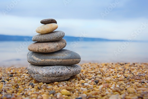pyramid of colorful pebbles . Rock Zen in the background of the sea. Concept of harmony and balance.