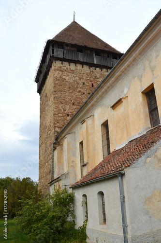 Fortified medieval saxon church in the village Barcut, Bekokten, Brekolten,Transylvania,Romania photo